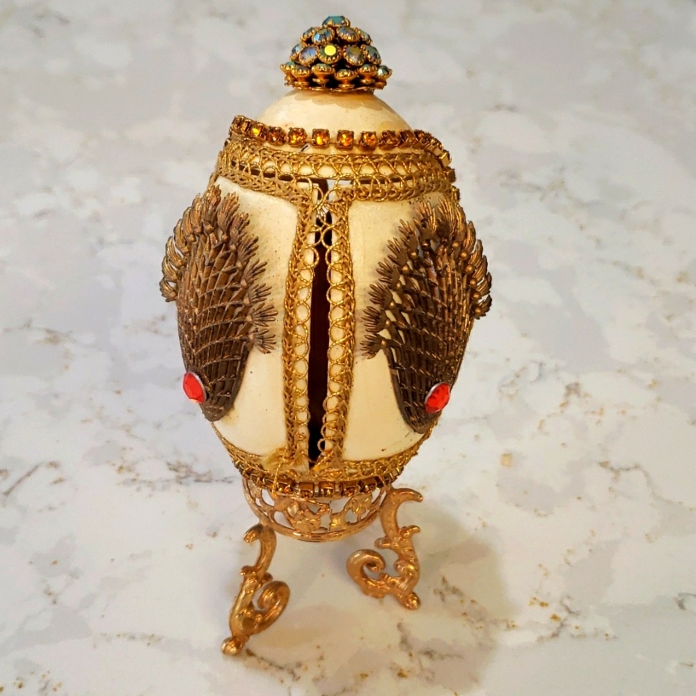 Decorative embellished egg with cherub inside